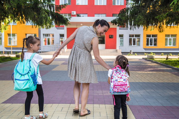 mother and daughters going to school